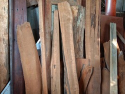 Set of wooden boards leaning against the wall
