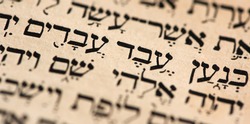 Closeup of hebrew words in Torah page that translate in english as Cursed be Canaan, a servant of servants shall he be to his brothers. Selective focus. Banner
