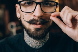 Well groomed hipster. Barbershop concept. Beauty industry. Facial hair care. Mature man bearded hipster with long beard and mustache. Styling mustache. Growing long mustache. Moustache style.