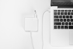 magSafe 2. Apple Power Adapter laptop charger.  MacBook keyboard a white background