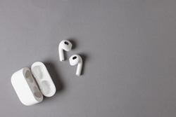 white wireless headphones on grey background