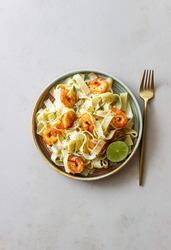 Pasta fettuccine in a creamy sauce with shrimp, lime and sage. Italian food