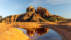 A reflection of Cathedral Rock in a small pool of water at Sedona, Arizona.
