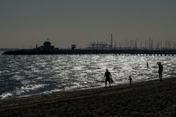 St Kilda, Melbourne/Australia-03/28/2019: View of the St Kilda Pier from the esplanade during a late autumn afternoon. Incidental light 
