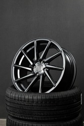 Black stylish forged sports shiny car rim on car tires