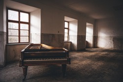 Old piano left in long abandoned chateau