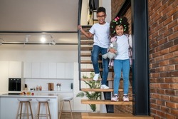 Boy and girl going down stairs at home