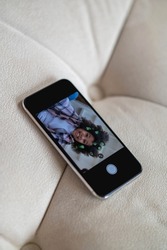 Top view of smartphone with photo of dark-skinned girl