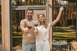 Couple posing for the camera with alcoholic beverages