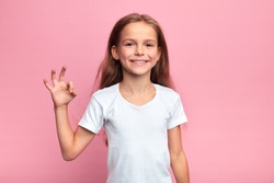 cheerful beautiful blonde girl showing okay sign, close up portrait, body languge, agreement, everything is ok, allright, isolated pink background, studio shot