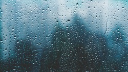 raindrops on a window. Rainy window at night. Drops on the black glass. dark blue wet, drops of water rain on glass background. concept of autumn weather.