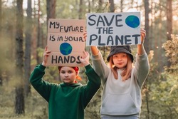 teenagers looking to camera with My Future in Your Hands poster support save planet  movement. youth volunteer protesting for safe ecology, global warming, pollution, plastic pollution.Earth World Day