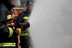 Firemen practice fighting the fire.Fireman team fire drills.