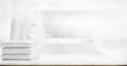  panorama shot : Towels on marble top table with copy space on blurred bathroom background. For product display montage.