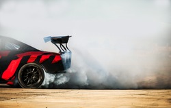 Car drifting, Blurred of image diffusion race drift car with lots of smoke  from burning tires on speed track Stock Photo