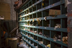 Storage cubby with shoes and labels in turn of the century silk throwing factory.