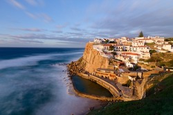 Azenhas do Mar, Portugal. Natural pool in the ocean, next to the cliff and a seaside village during sunset. Best destinations in the world. Most visited places. Holidays. Scenic and exotic. 
