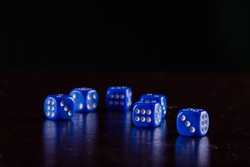 Six blue dice on black background