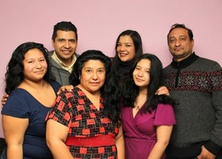 Portrait of a real Mexican Latino family with diverse bodies with father, mother, sons and brothers very happy posing to the camera
