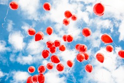 red balloons in the blue sky