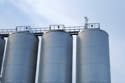 three brewery silos or tanks typically use for storing barley or fermeted beer
