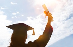 young woman student hands up celebrating university graduate