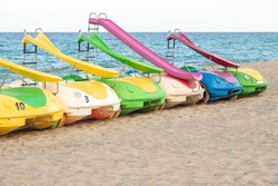 Pedal boats in the beach. Colorful plastic pedal boats to rent.