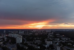 Epic vivid sunset above city residential district, aerial view. 23 serpnia, Pavlovo Pole, Kharkiv, Ukraine. Majestic evening skyscape, cloudscape and streets