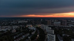 Epic vivid sunset above city residential district, aerial panorama view. 23 serpnia, Pavlovo Pole, Kharkiv, Ukraine. Majestic evening skyscape, cloudscape and streets