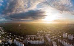 Sunrise bright panorama view in city residential district. Aerial Pavlovo Pole, Kharkiv, Ukraine. Morning sunny skyscape, cloudscape and streets