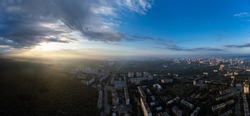 Peaceful sunrise cloudscape panorama view in green city residential district. Aerial Pavlovo Pole, Kharkiv Ukraine. Morning skyscape, cloudscape and streets