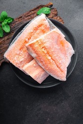 char fish frozen raw seafood freezy cooking red fish pieces long-term storage healthy meal food snack on the table copy space food background rustic top view pescatarian diet
