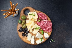 snack plate cheese, sausage, olive, bread stick fresh appetizer healthy meal food diet snack on the table copy space food background rustic 