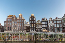 Amsterdam floating flower market and tall canal houses