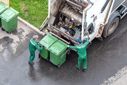two workers loading mixed domestic waste in waste collection truck