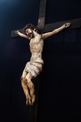 Old traditional wooden crucifix. Jesus Christ sculpture.