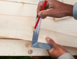 Measuring with a square. Tool for measuring. Joiner's (carpenter's) workshop. Close-up.