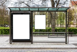 Blank white mock up of vertical billboard in a bus stop