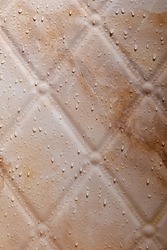 Wet brown marble tile in the bathroom. Water drops on the wall in the shower room
