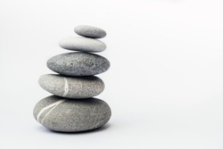 Stone cairn on light background, stones tower, simple poise stones. Purity harmony and Balance Concept. Place for text.