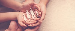hands holding paper family cutout, family home, foster care, homeless support,world mental health day, Autism support,homeschooling education, domestic violence, social distancing concept