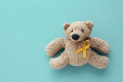 Children soft toy brown bear with yellow gold ribbon, Childhood cancer awareness
