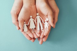 hands holding paper family cutout, family home, adoption, foster care, homeless charity , family mental health, homeschooling education, Autism support, domestic violence, social distancing concept