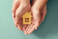 hands holding paper house, family home, homeless housing, mortgage crisis and home protecting insurance concept, international day of families, foster home care, family day care, social distancing
