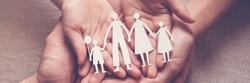 Adult and children hands holding paper family cutout, family home, adoption, foster care, homeless support, family mental health, autism support, domestic violence, social distancing concept
