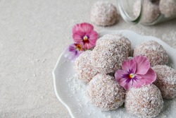 Homemade strawberry, date, nuts and coconut bliss ball with edible flowers, keto, ketogenic, low carb diet, sugar free, dairy free and gluten free dessert