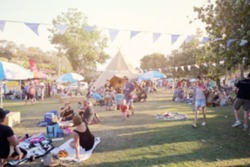 Blur defocused background of people, family in park fair, festive summer, music festival tent