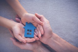 hands holding paper house, family home, homeless housing, mortgage crisis and home protecting insurance concept, international day of families, foster home care, family day care, social distancing