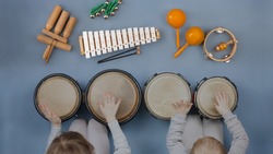 Boy girl kids playing orff instruments - Musical instruments for children: drums, flute, metallophone 