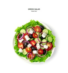 A plate of Greek salad on a white background. Top view. The concept of proper nutrition.